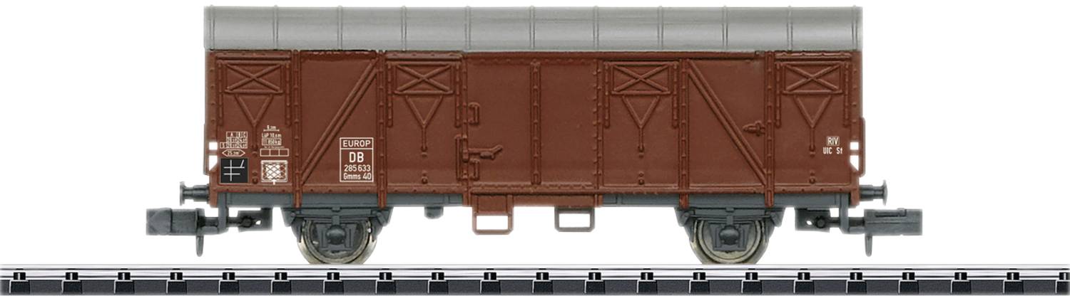 A brown freight wagon of Deutsche Bahn on a railway track. The wagon has a grey tarpaulin covering the roof and visible markings.