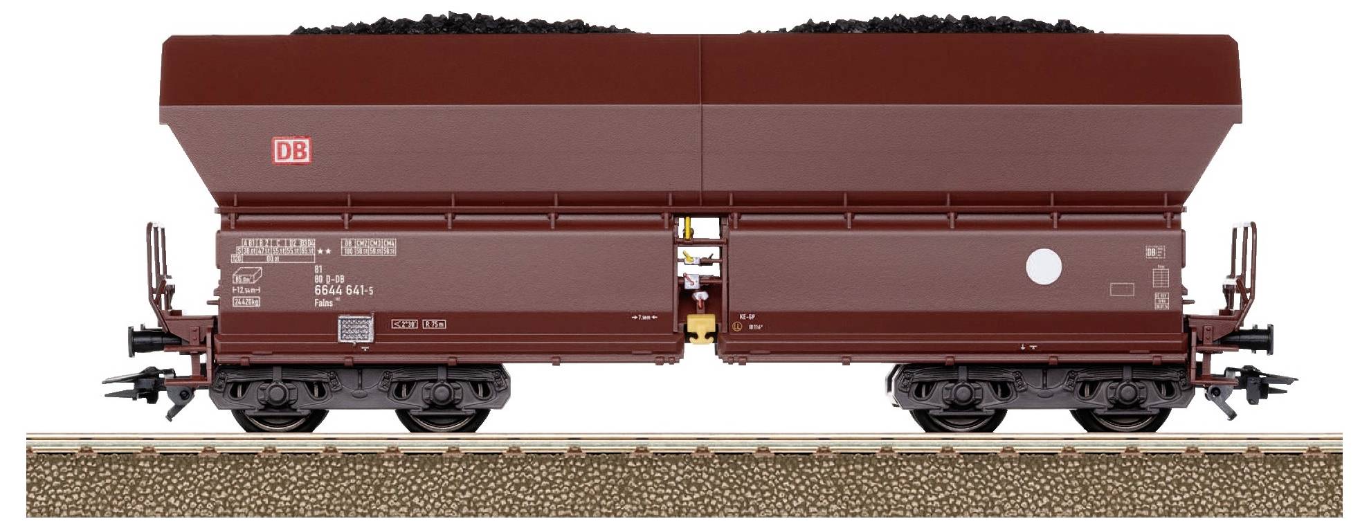 Brown goods wagon loaded with coal, photographed from the side of the track.