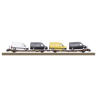 'Four transporters on a goods wagon, coloured: white, black, yellow, black.'
