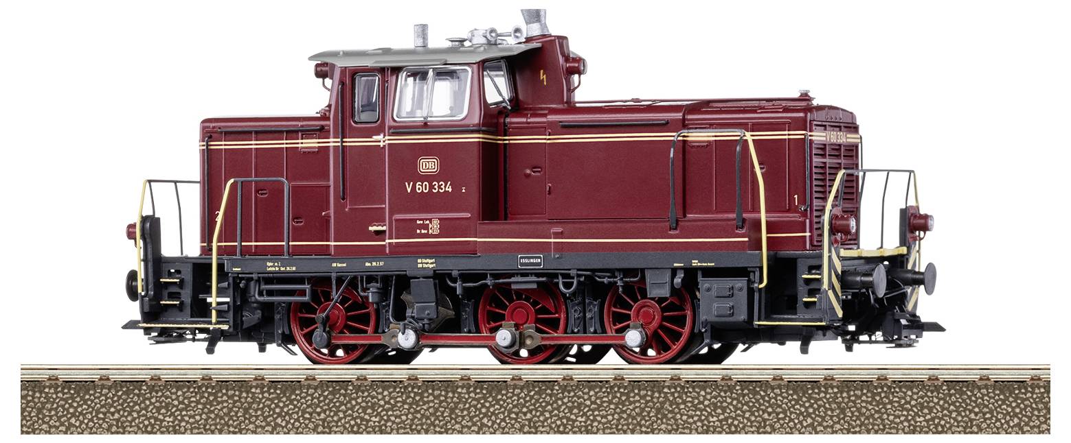 A red diesel locomotive designated 'V 60 334' stands on a track. It has black and red details and a driver's cab.