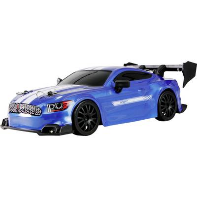 Blue remote-controlled model car with racing spoiler on white background, side view. The car has black wheels and tinted windows.