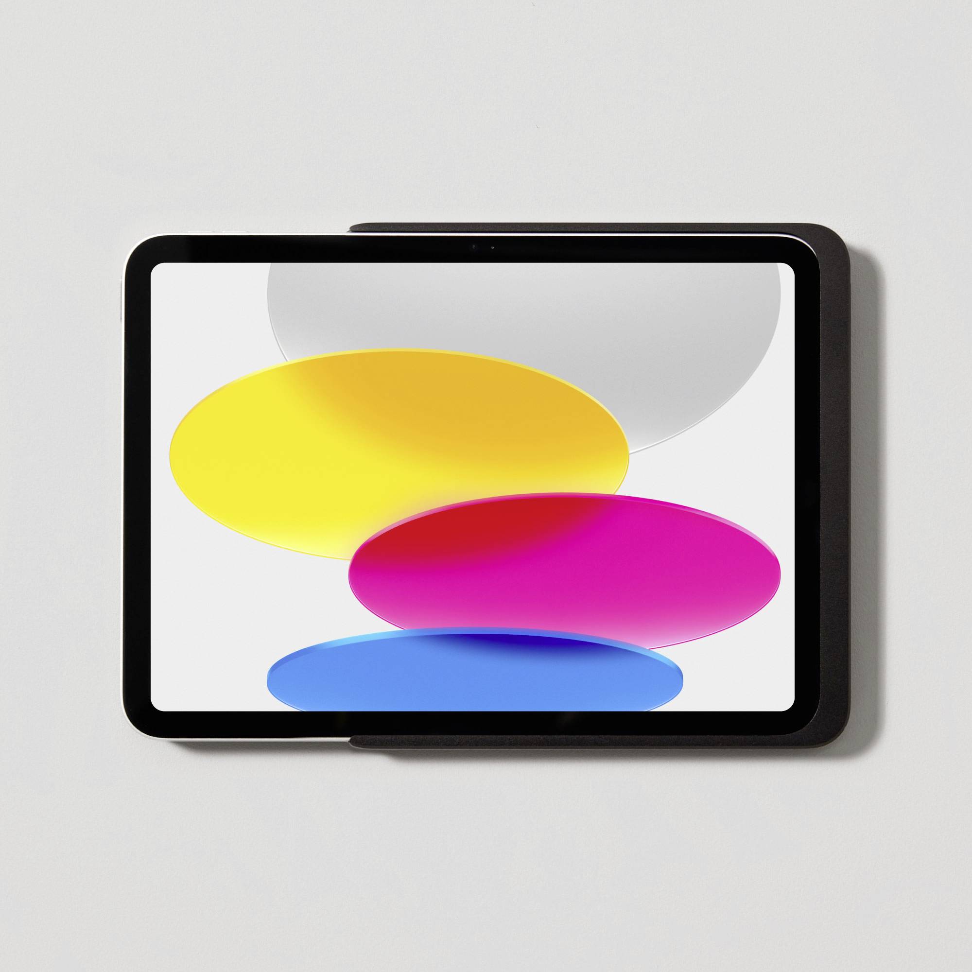 A tablet with a display showing three overlapping, colourful circles in yellow, pink, and blue, against a white background.