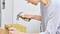 A person is hammering a nail into a piece of wood.