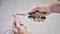 A person is holding a pair of pliers and connecting cables, possibly during electrical work or a repair.