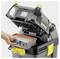Industrial vacuum cleaner with open lid, person changing the filter. Device in grey and yellow colours, brand name visible.