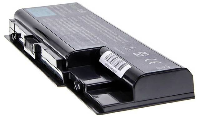 A black laptop battery lies flat on a white surface, with its top side displaying technical labels and a barcode.