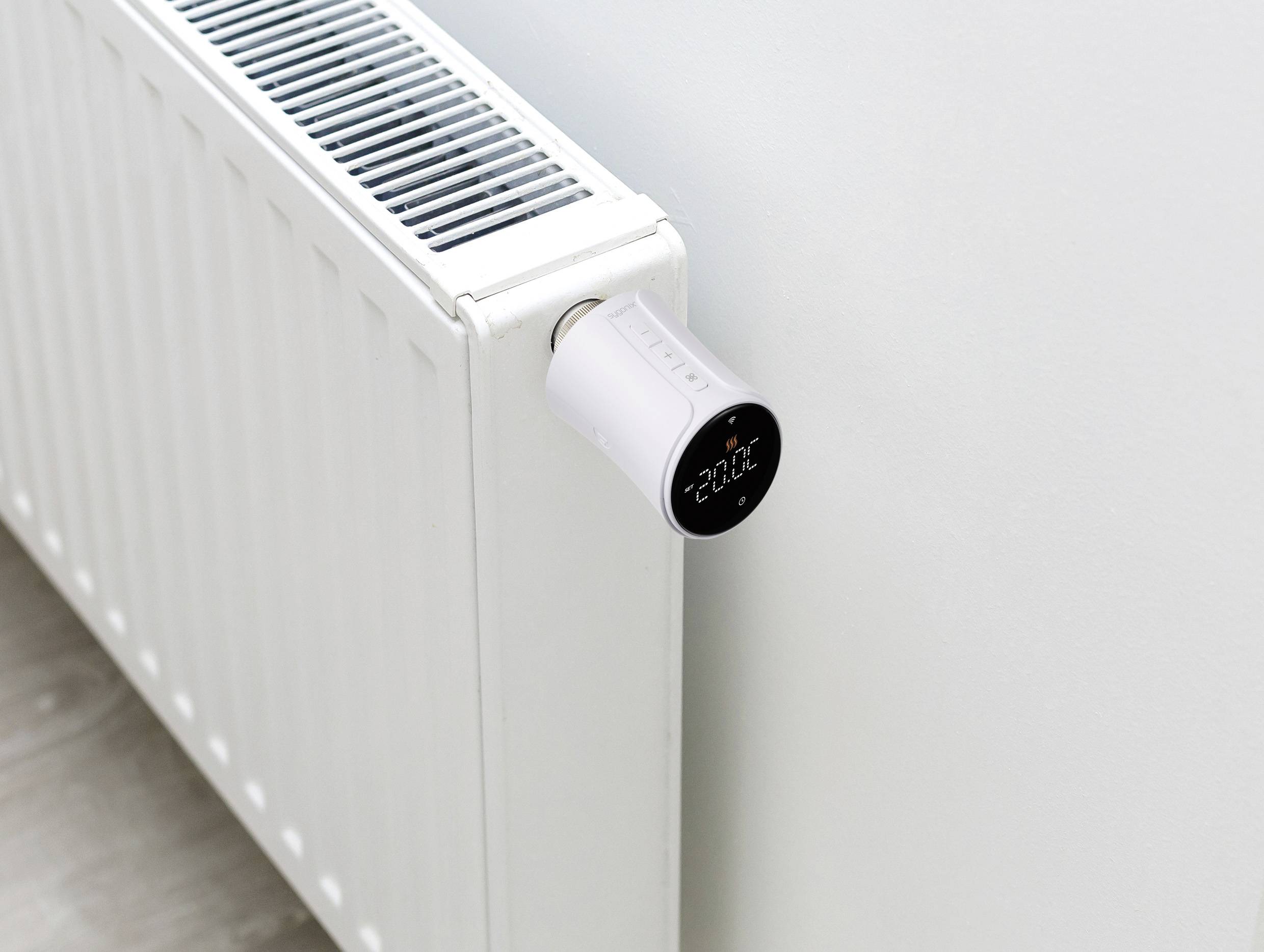 A radiator with a digital thermostat on the side, displaying a temperature of 22°C.