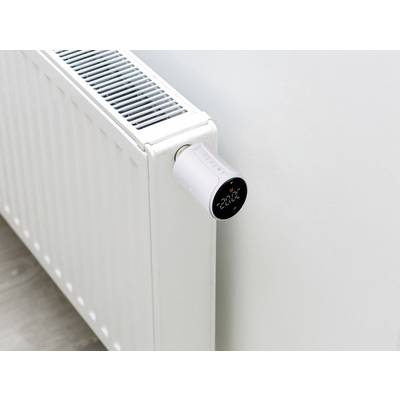 A radiator with a digital thermostat on the side, displaying a temperature of 22°C.