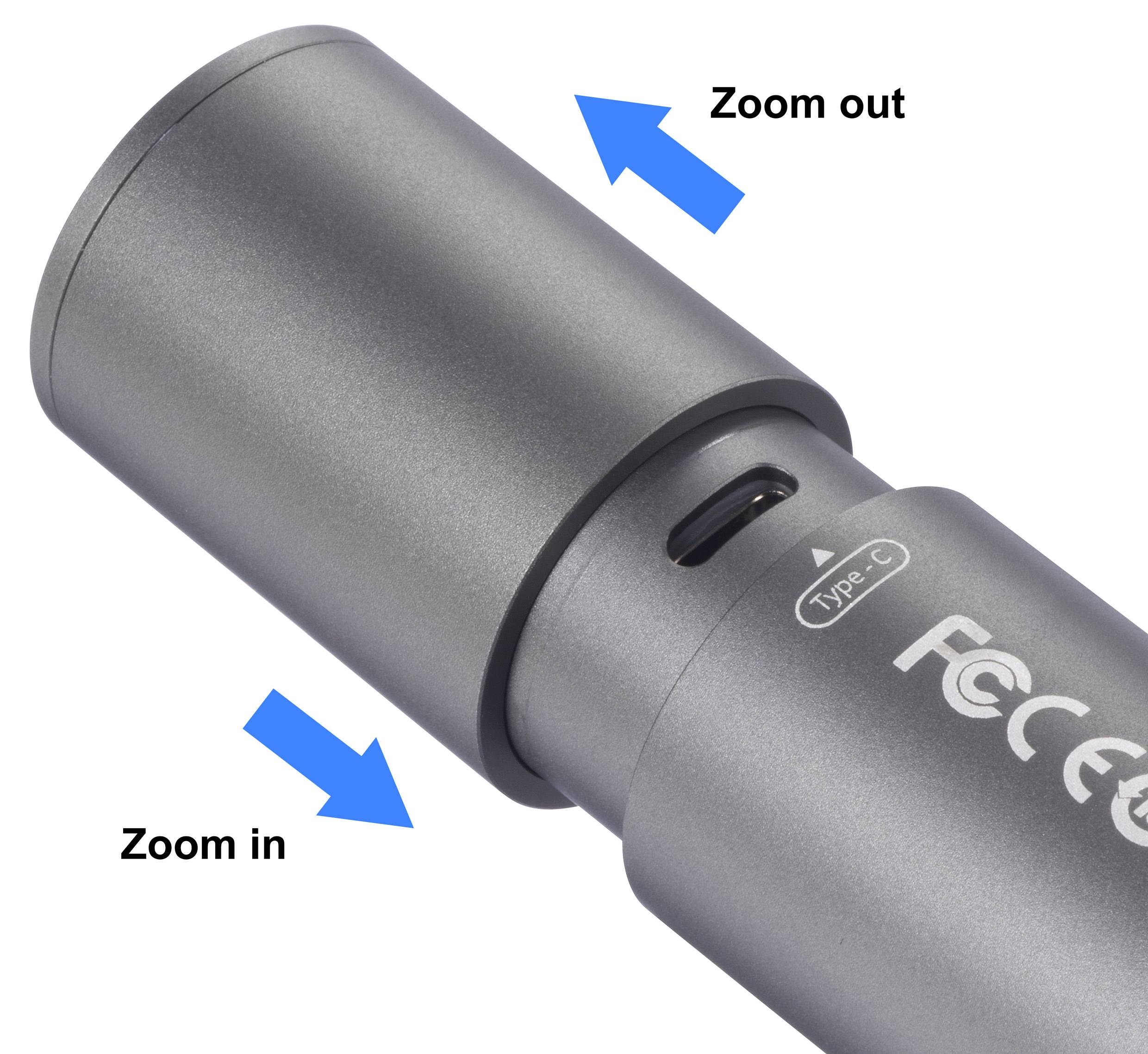 Silver cylindrical device with zoom function, marked by blue arrows: 'Zoom in' and 'Zoom out'.