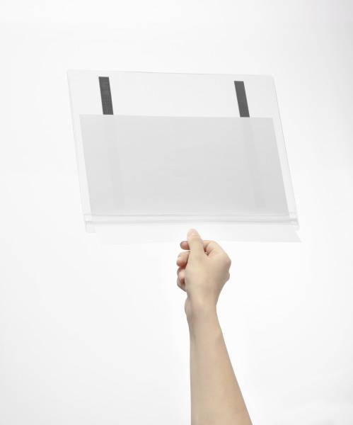 A hand is holding a transparent document folder against a white background. The folder has black fastening elements.