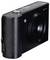 A black digital camera with a large lens in the centre and several control buttons on the top surface.