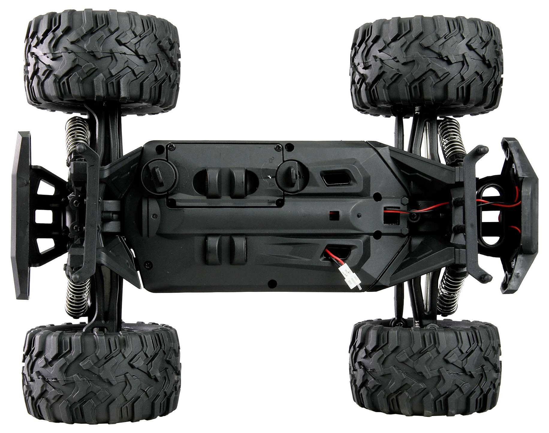 Underside of a remote-controlled car with large tyres and suspension, showing the complex chassis design and wired electronics.