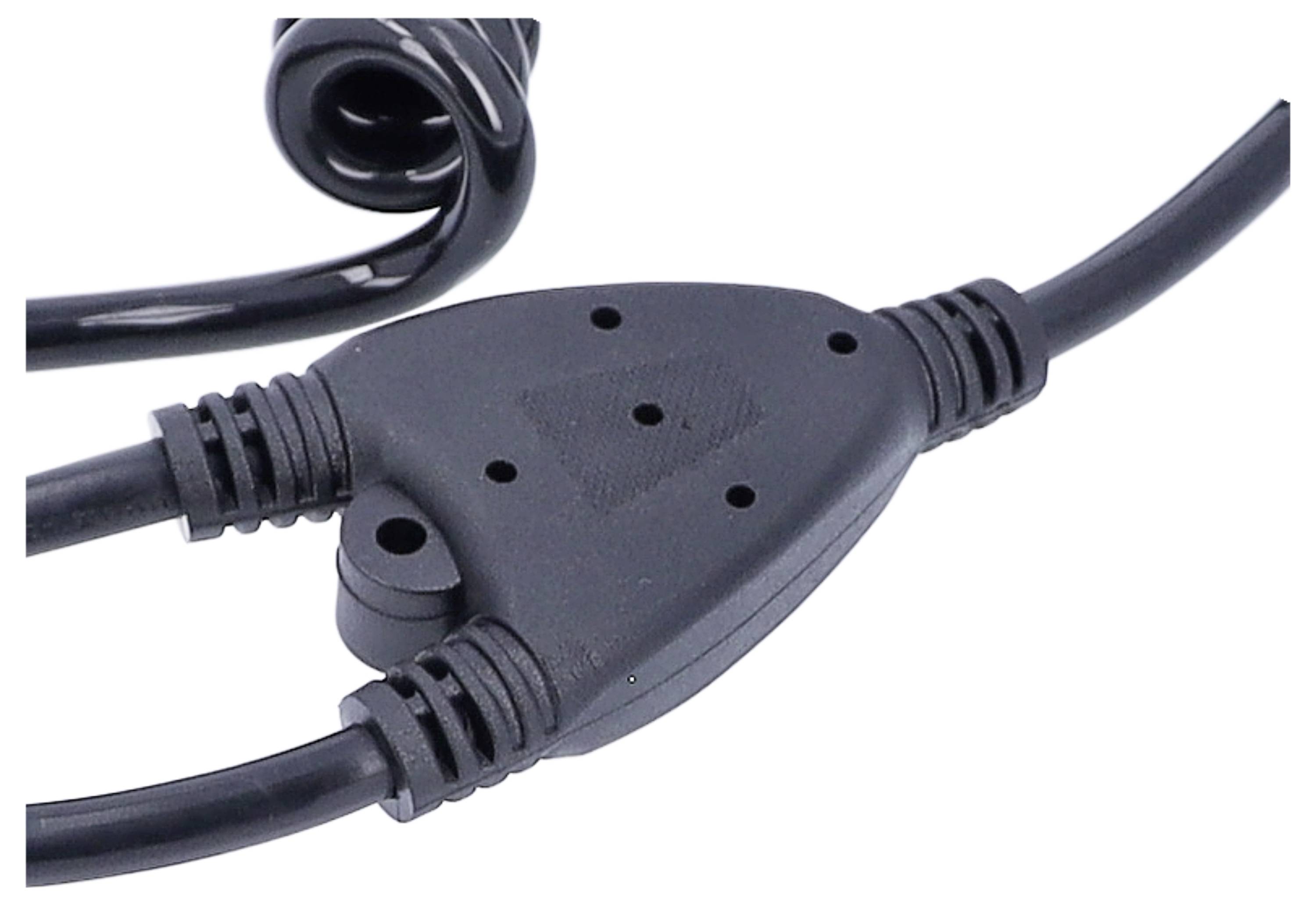 Black cable distributor with three plug connections and a spiral-shaped cable section in the background.