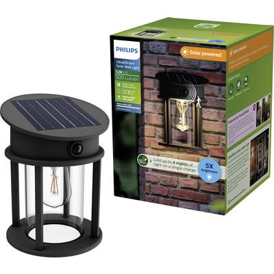 A black, solar-powered Philips wall light with an Edison light bulb. The packaging displays an image of the light fixture on a brick wall.