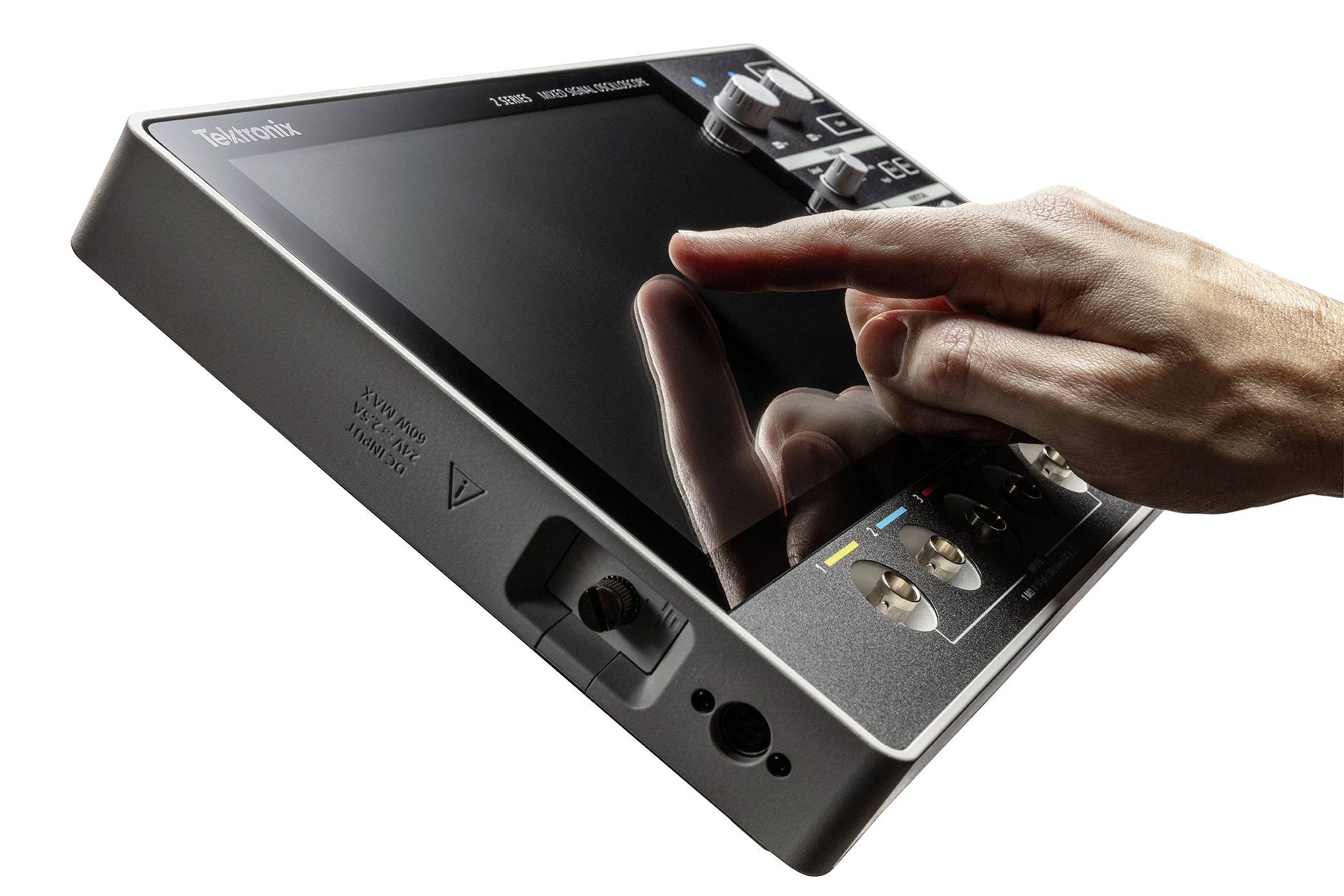 A hand is operating a tilted touchscreen device.