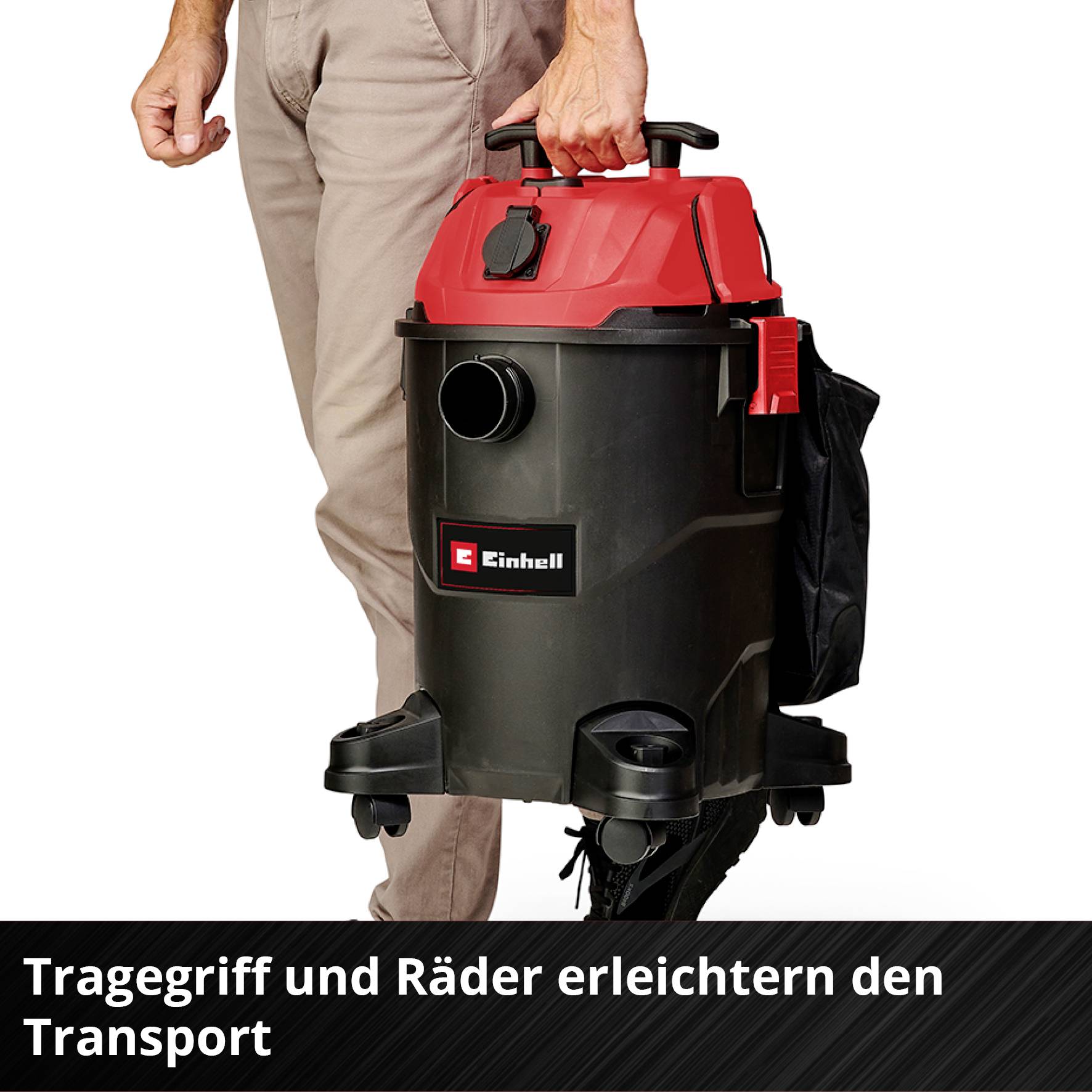 A man is carrying a red and black vacuum cleaner with a carrying handle. The text reads: 'Carrying handle and wheels make transportation easier'.