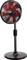 A black pedestal fan with red blades and adjustable height stands in front of a neutral background.