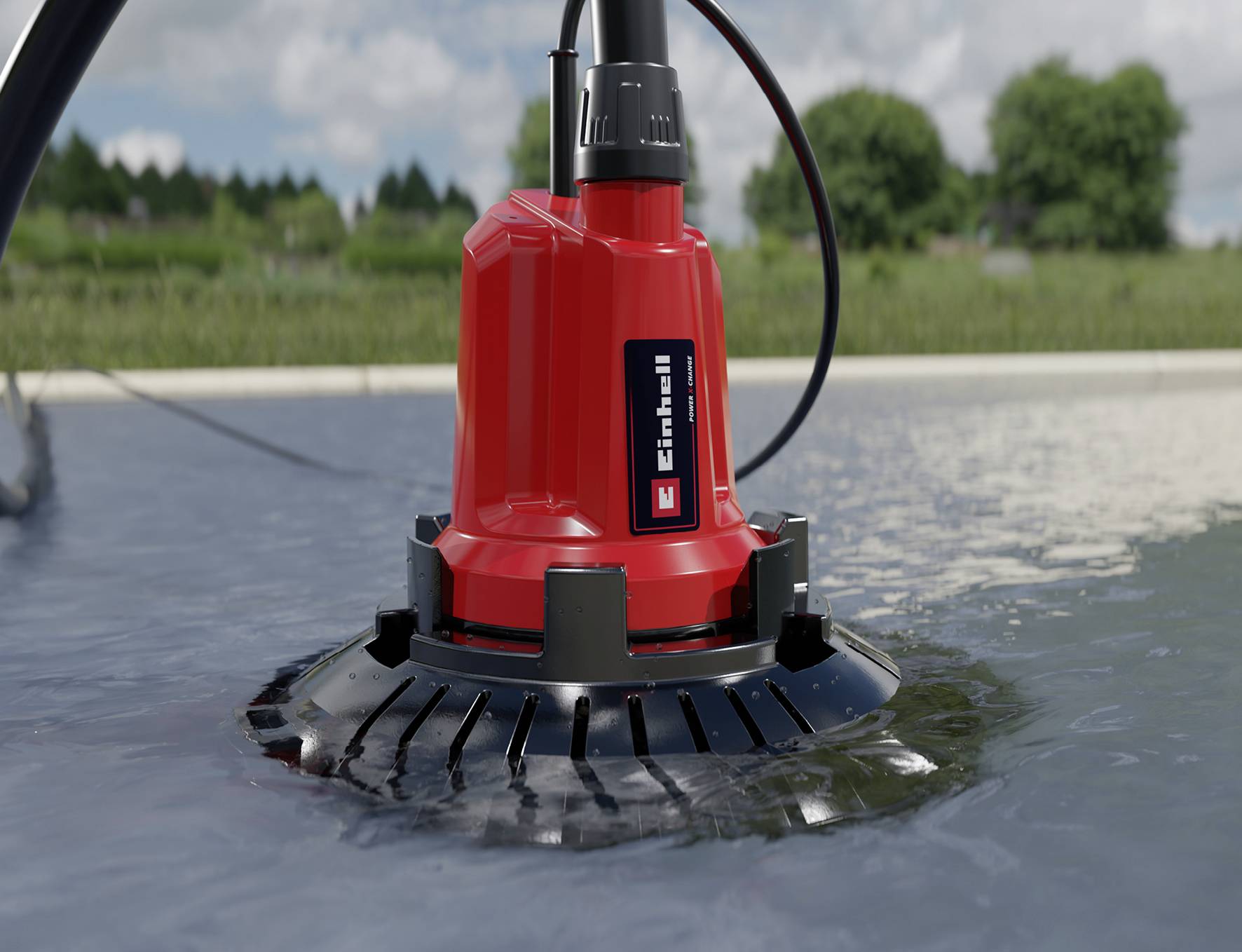 A red submersible pump, partially submerged in water, can be seen in a natural setting. It bears the 'Einhell' logo. Trees and sky are visible in the background.