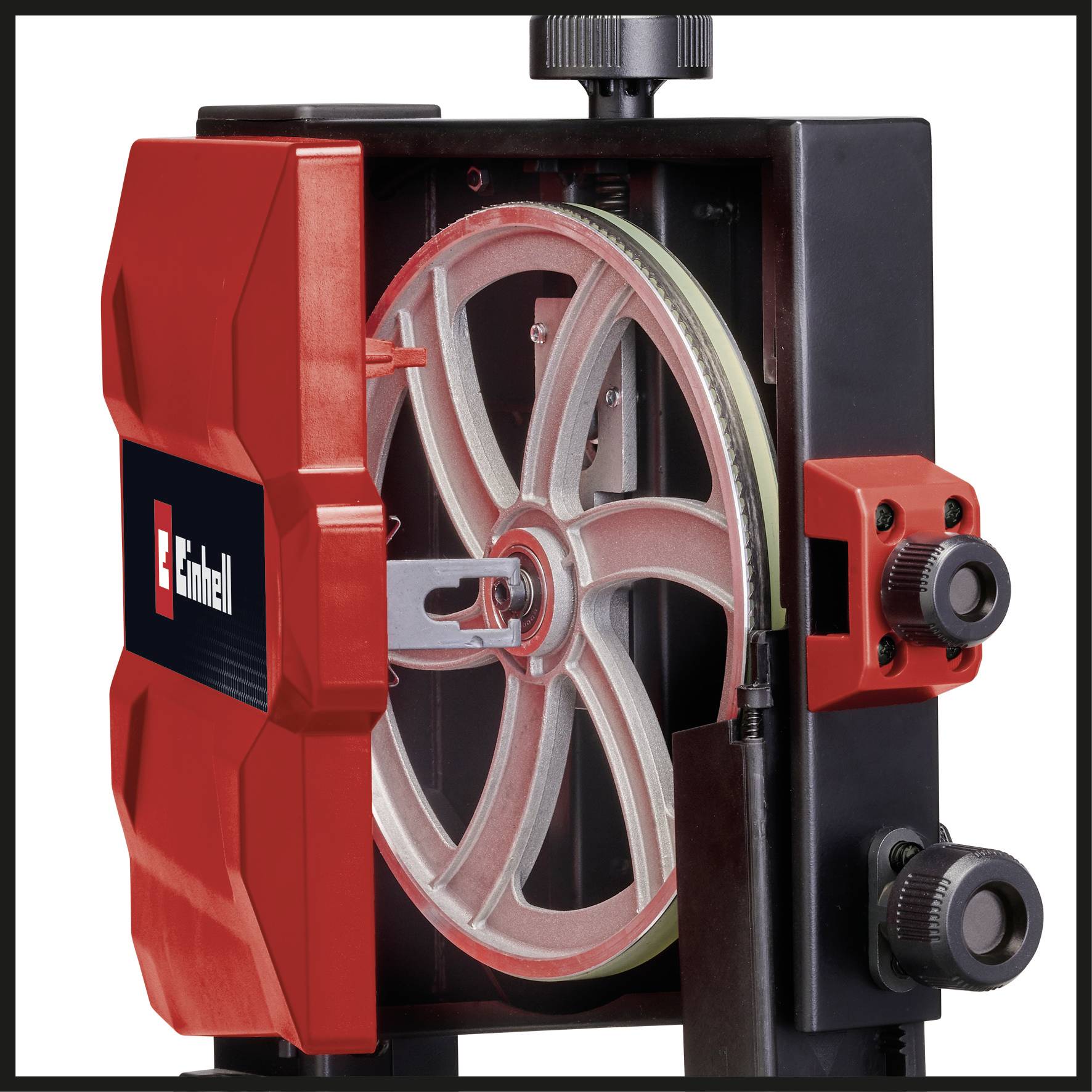 A red and black device with a large metal wheel inside, possibly part of a machine or tool.