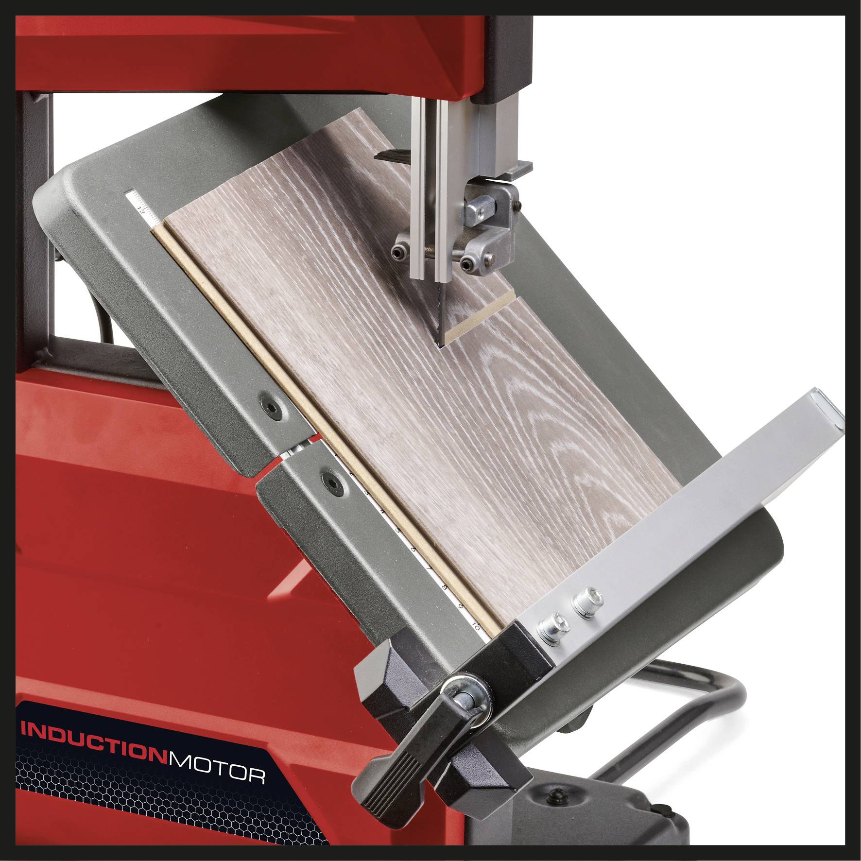 Woodworking bandsaw demonstrates precise cutting of a wooden board. The machine has a red cover and a silver cutting arch.