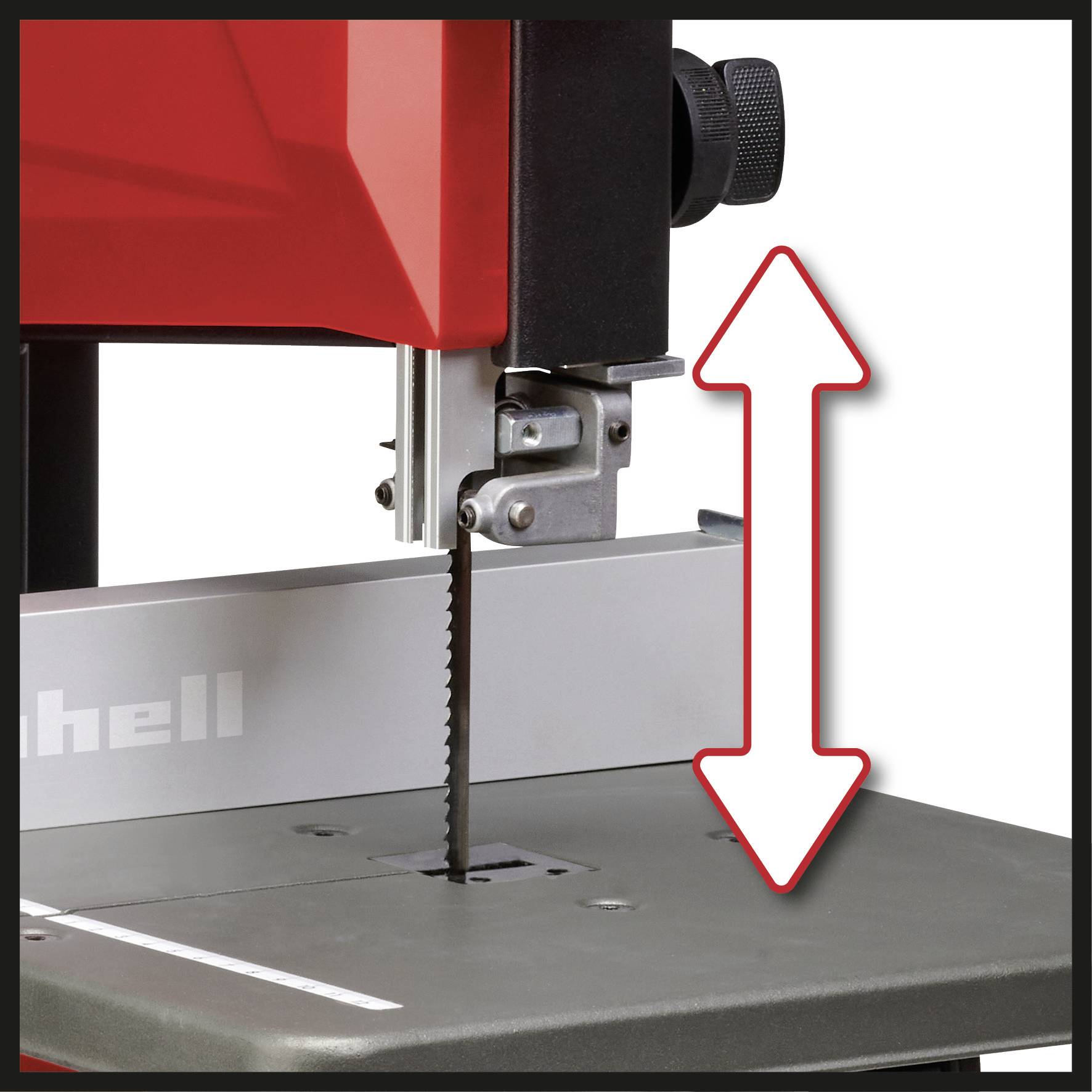 Band saw with an arrow indicating the adjustable saw table height. Saw blade in the centre.