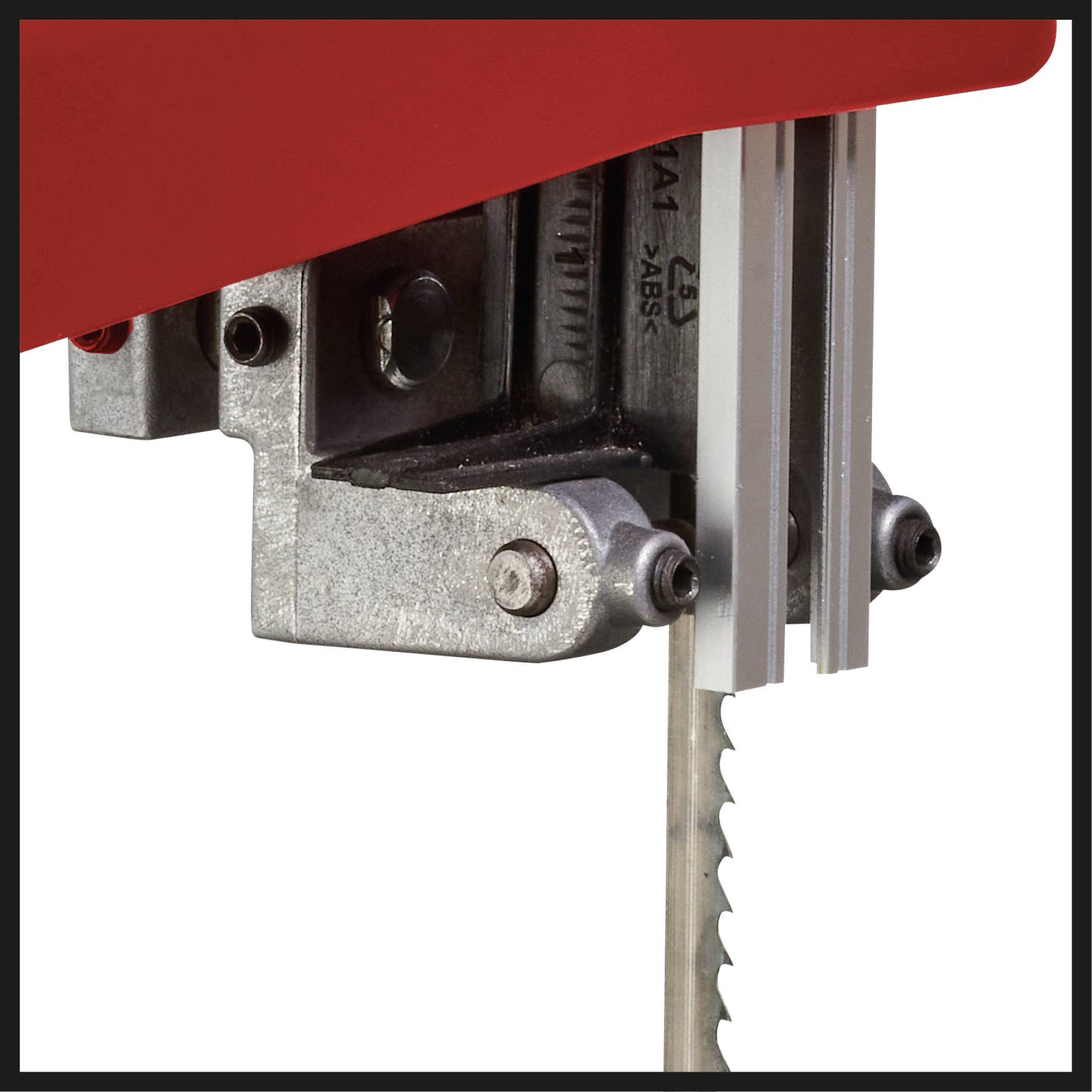 Close-up of a metal saw in action. The focus is on the saw blade shape and part of the housing.