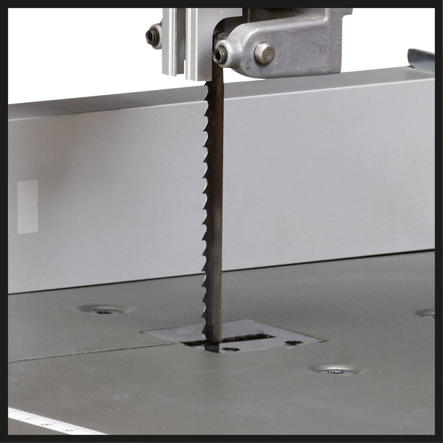 Close-up of a bandsaw in operation, cutting a metal blade. The machine shows the saw blade area in detail.