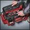 A red tool bag with an unzipped zip reveals various tools, including screwdrivers, pliers and a hammer. Two hands are arranging the tools.