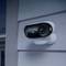 Weather-resistant surveillance camera mounted on the exterior wall of a house, ready to capture security footage.