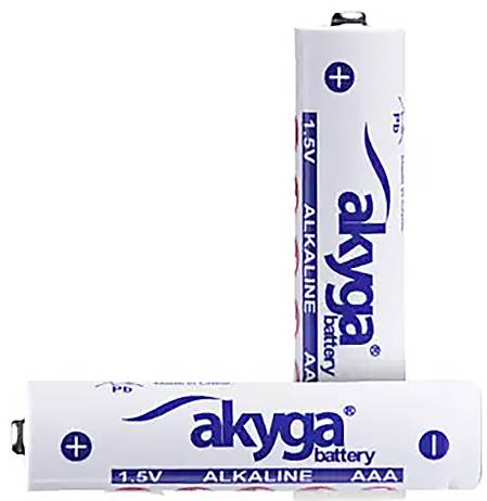 Two white AAA alkaline batteries by the brand 'akyga' with a voltage of 1.5 V, one standing and the other lying down.