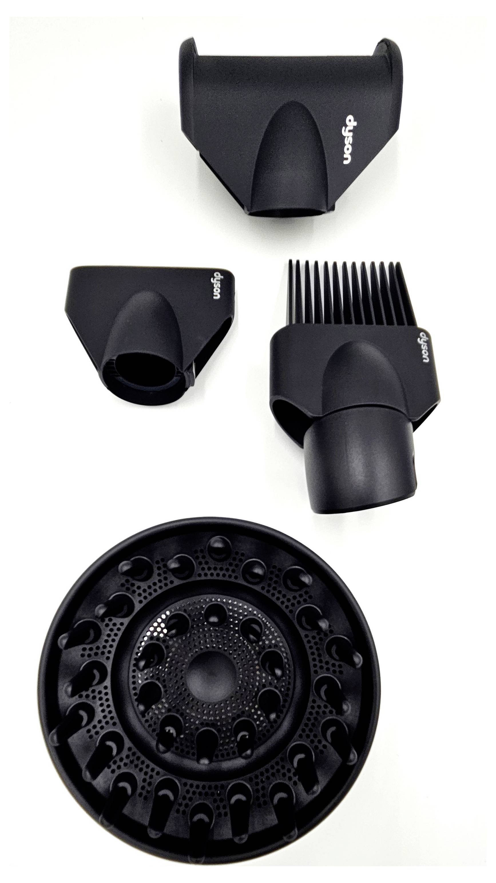 Black hairdryer attachments on a white background: diffuser, comb attachment, two nozzles.