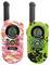 Two colourful walkie-talkies, one in pink and one in green, with a digital display and buttons. Both are showing channel 1.