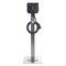 A black electric vehicle charging station on a metal stand with an attached charging cable.
