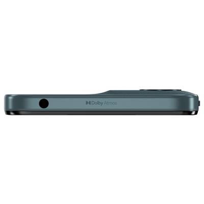 A close-up of a smartphone's top edge in teal color, featuring a 3.5mm headphone jack on the left and 'Dolby Atmos' branding in the center.