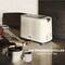 A toaster on the worktop beside mugs and jam in the sunlight with the text 'A tasteful start to the day'.
