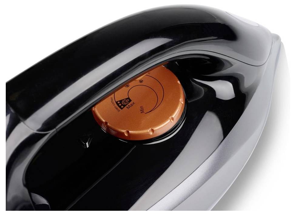 A black iron with an orange temperature control dial on the top surface.