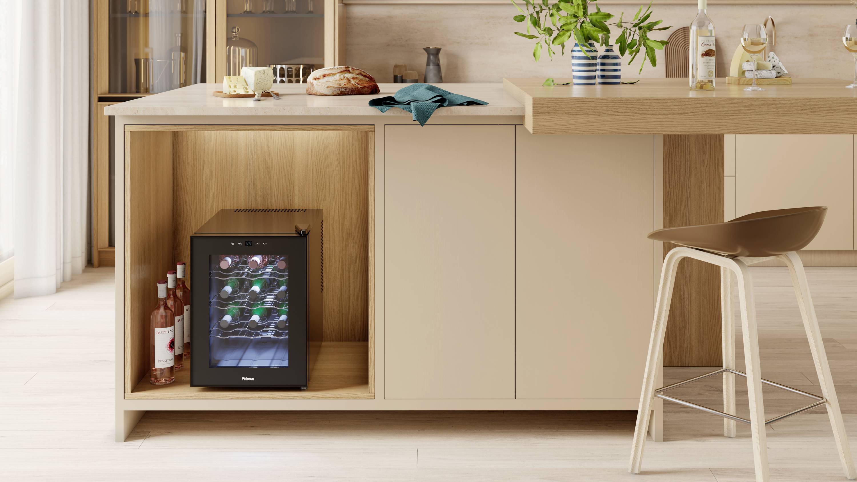 A modern kitchen with a built-in wine rack, filled with bottles. Bread, cheese, and plants are placed on the worktop.