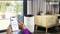 A person is checking air quality on a smartphone. A Bosch air purifier stands nearby in a modern living room.