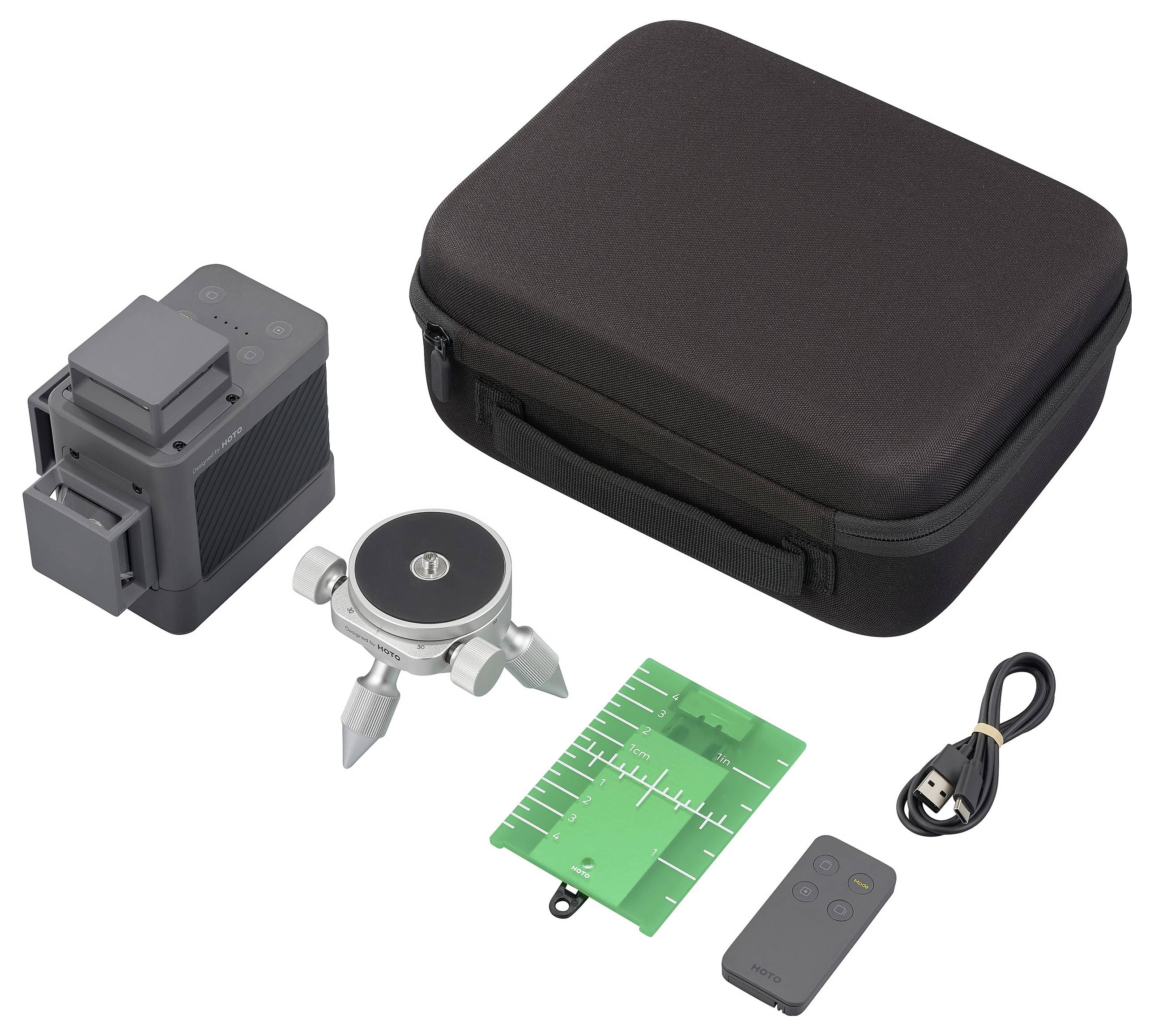 The image shows a projector with accessories: a black carry case, a charger, a green circuit board, a mesh-like object, and a remote control.