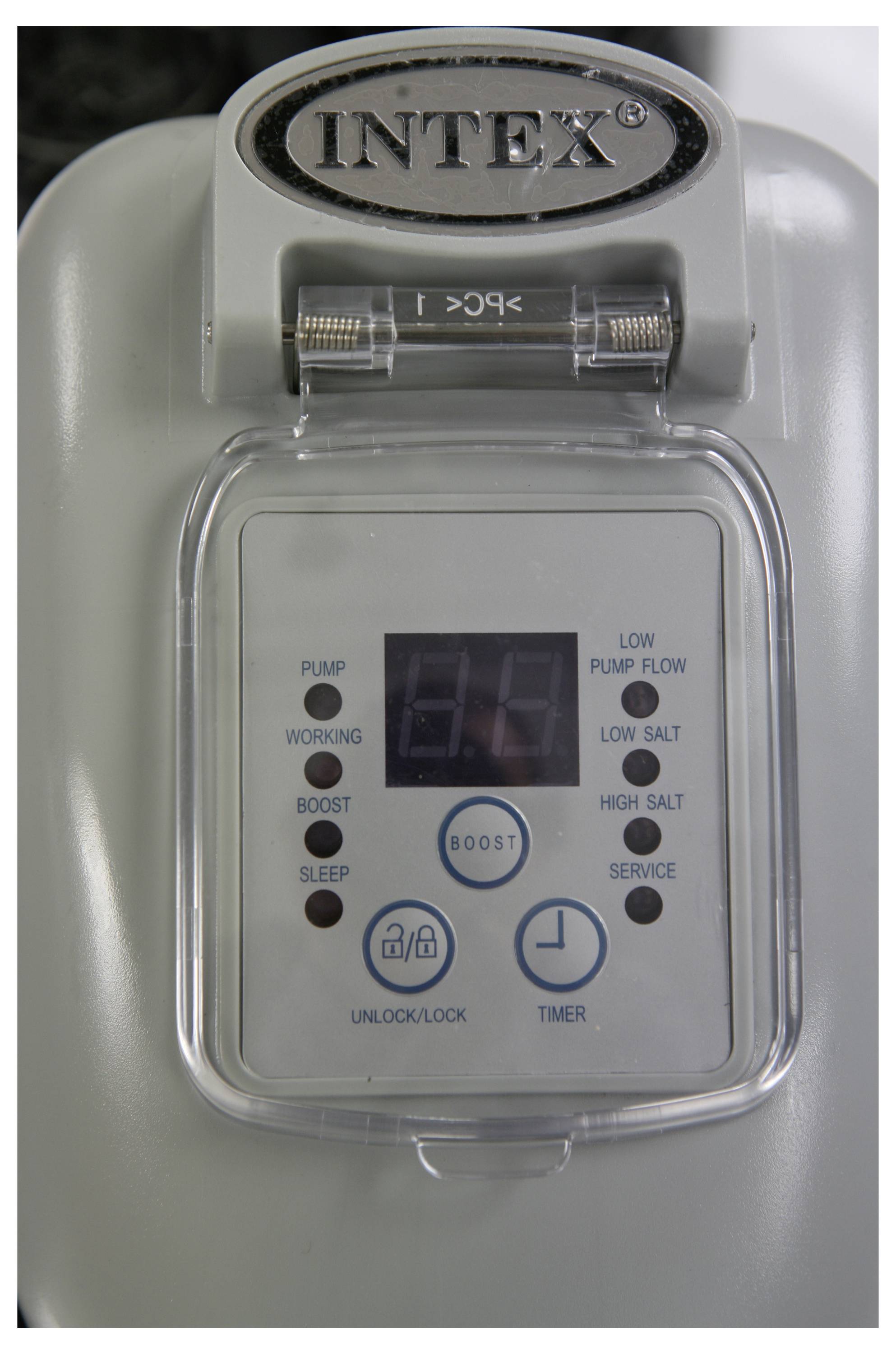 A control panel of a pool filter system with a digital display, buttons for 'Pump', 'Boost', 'Sleep', and indicators for salt level and service.