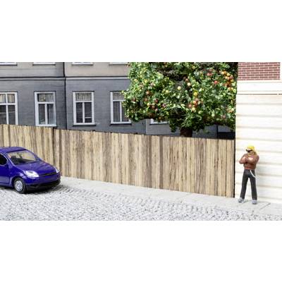A model of a neighbourhood with a miniature car and figure on a cobblestone street, with a tree beside it.