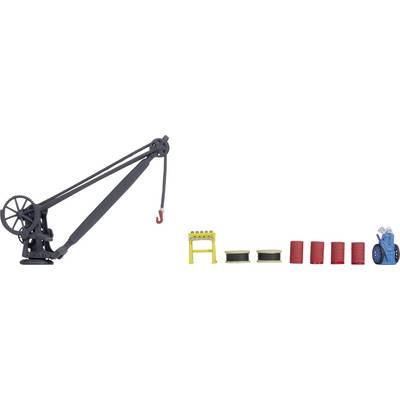 A model crane with a red hook on the left. On the right, yellow beams, spools, red barrels, and a blue machine component are arranged.