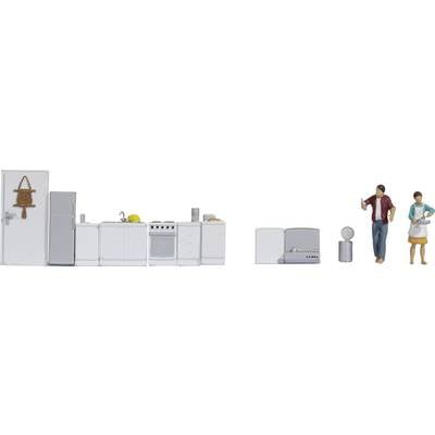 Miniature kitchen scene with figures: A man and a woman in a modern kitchen with appliances such as a cooker and fridge.