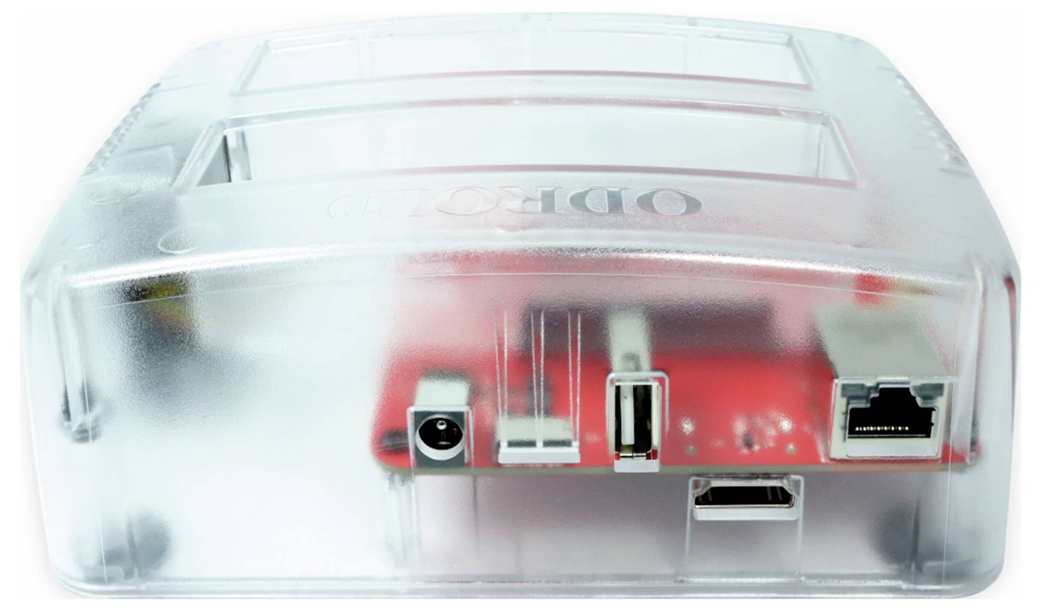 A transparent plastic case reveals a red circuit board with multiple ports: power, USB, HDMI and Ethernet.