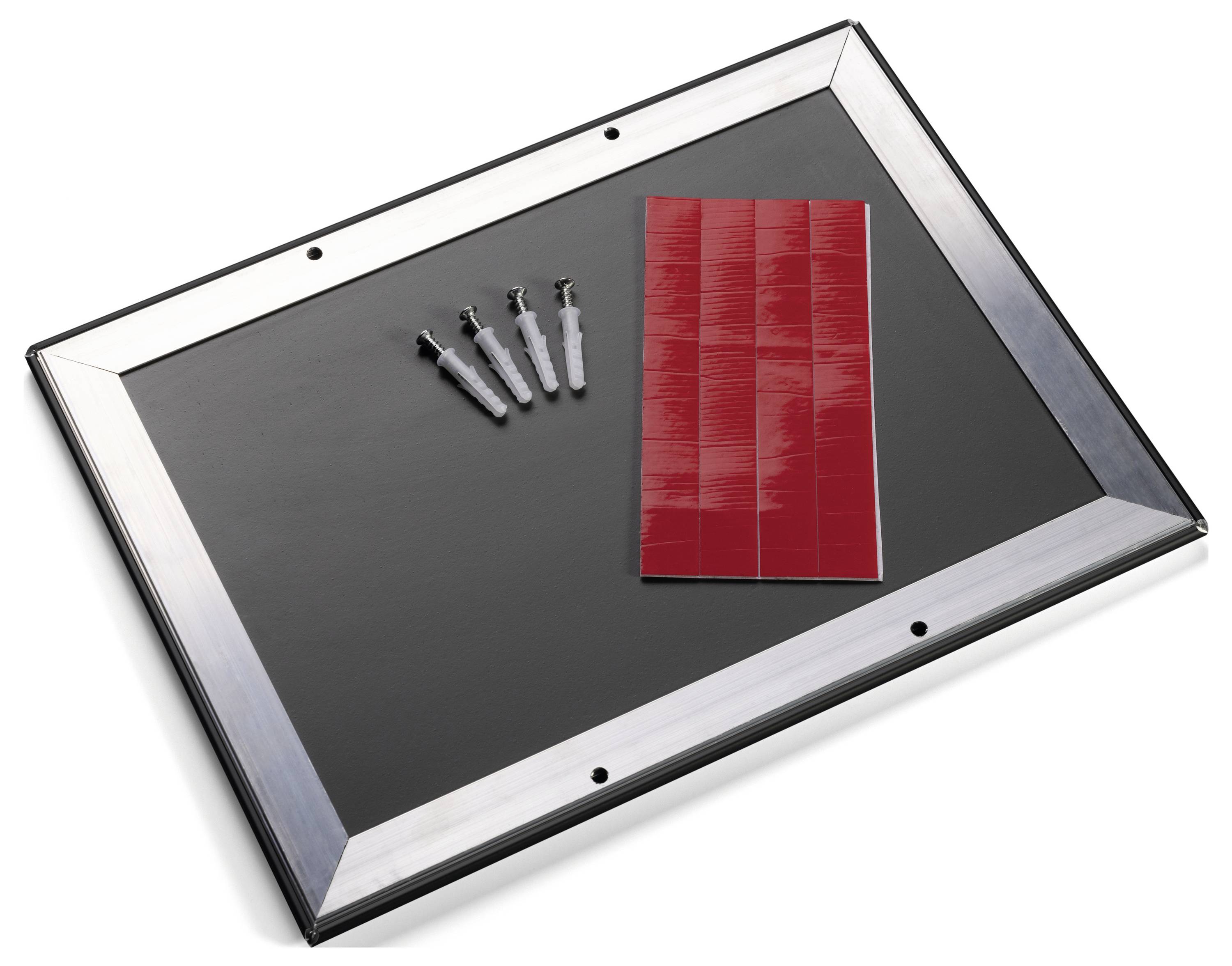 A rectangular black picture frame with four wall mounts, with a red brick pattern sample placed on top of it.