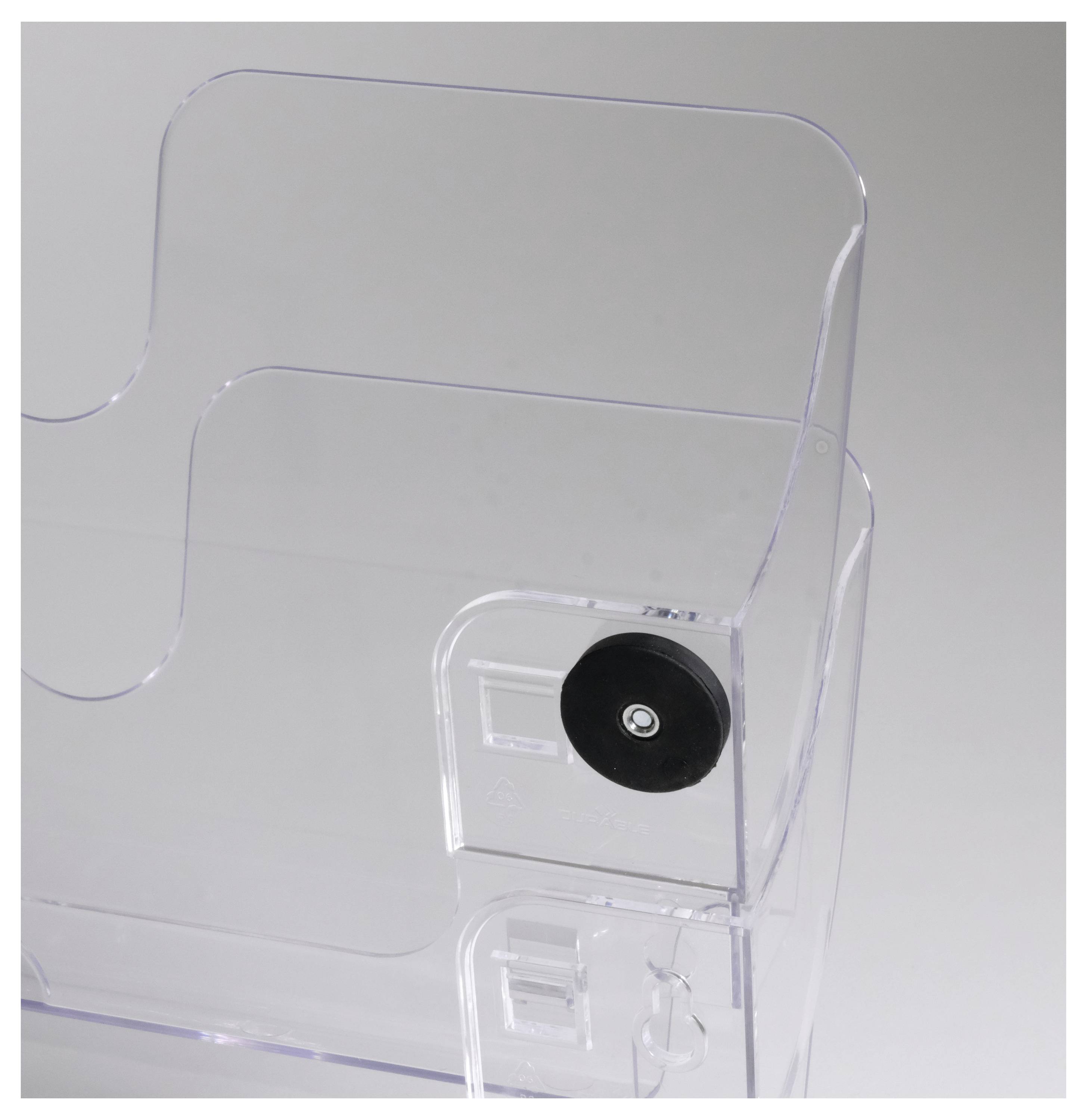 Transparent compartment with a black rotary knob, suitable for storing papers or brochures, shown standing independently.