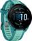A turquoise smartwatch displays a large digital time of '10:10'. The display also shows the date, battery status, and step count.