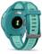 Back of a blue sports watch with heart rate sensor and brand name, showing sensors and strap clasp.
