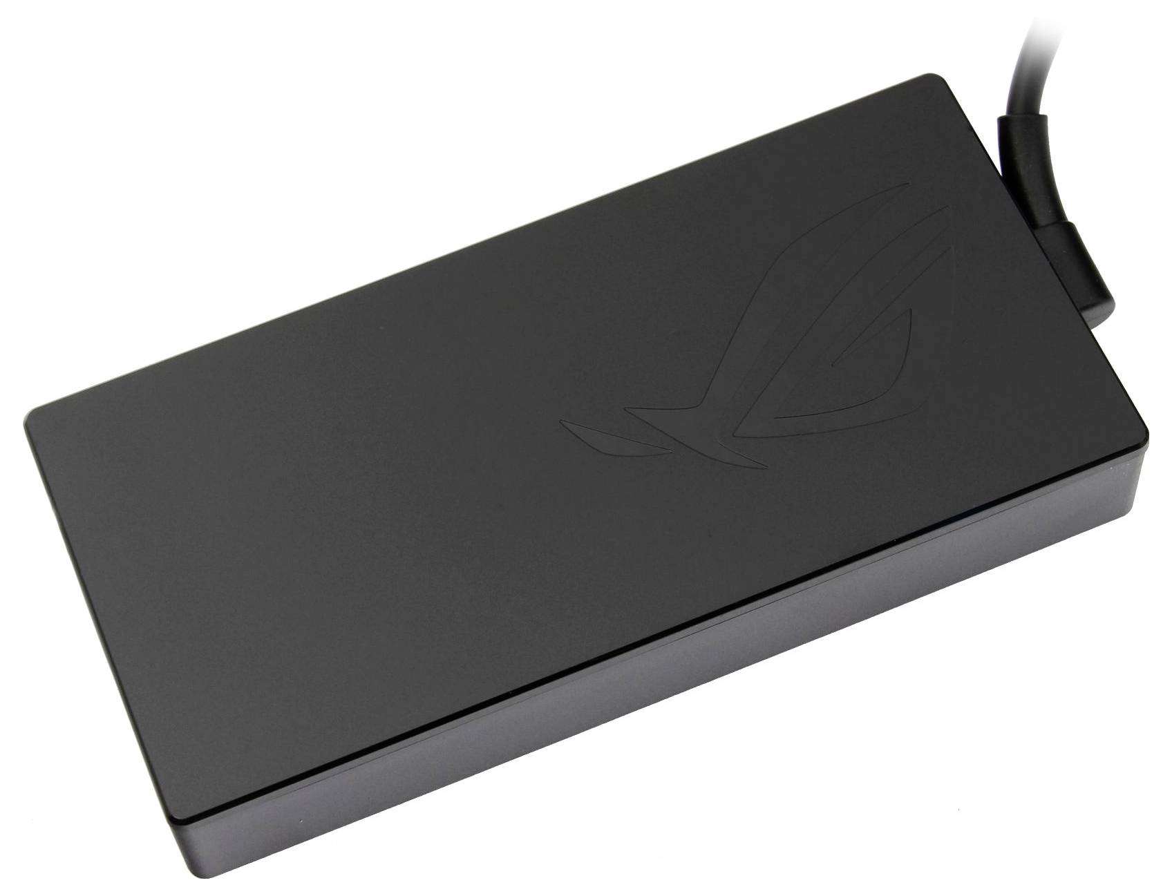 A rectangular, black power adapter with a slightly distinguishable logo on the top surface, with a cable emerging from one corner.