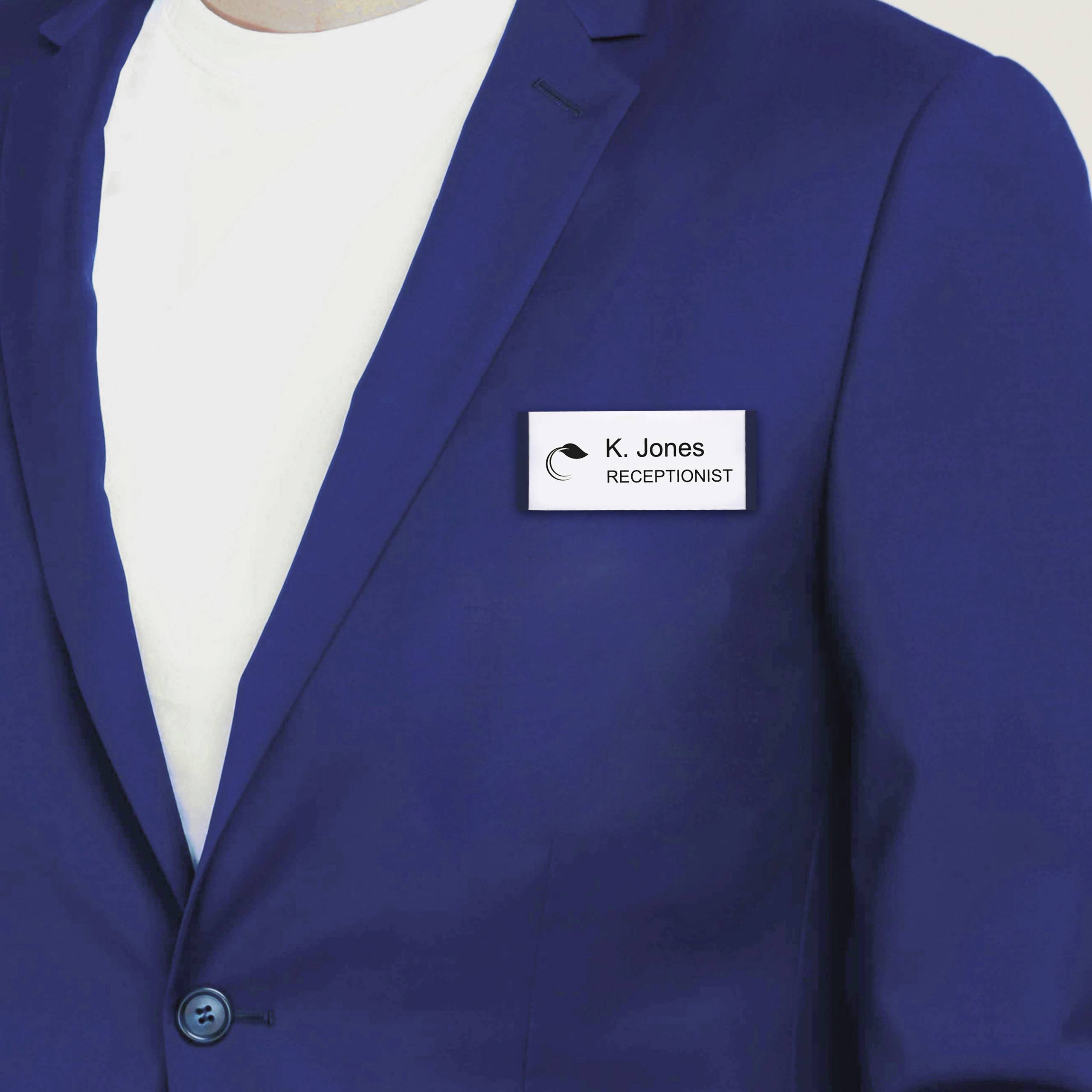 A person is wearing a navy blue blazer with a name badge on the chest that reads 'K. Jones, Receptionist'.